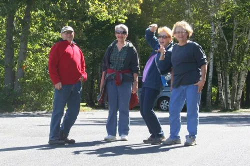 Four CWN members striking playful poses on a hike in Door County