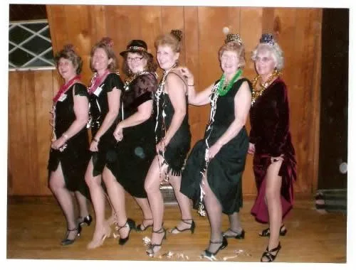 Six CWN women in flapper dresses and headbands on New Year's Eve